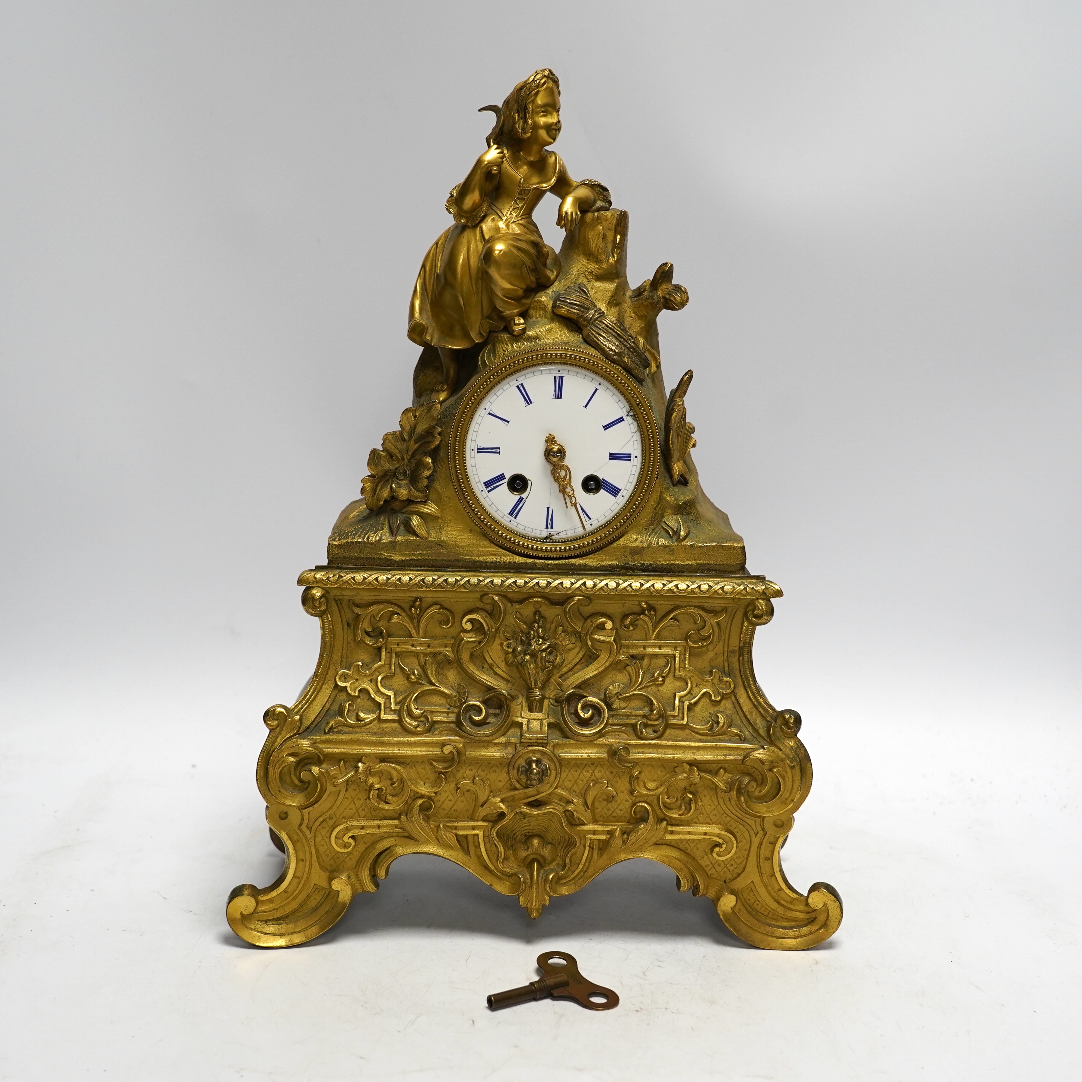 A mid 19th century French ormolu figural mounted clock with silk suspension, with key, 36cm